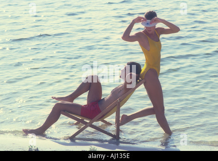 couple relaxing on beach Stock Photo