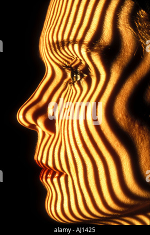 contour stripes projected on woman s face closeup Stock Photo