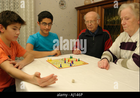 grandparents and their grandsons are playing a board game Stock Photo