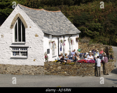 People enjoying a drink outside  at the riverside tea rooms, Boscastle Stock Photo