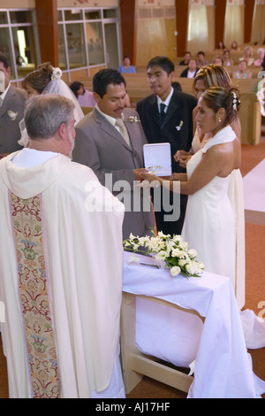 Catholic Priest administers wedding vows to Latino American at St Thomas Catholic Church in Ojai California Stock Photo