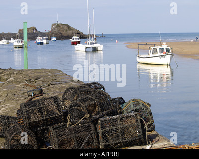 Bude harbour, with fishing boats and pleasure boats in the water. Lobster pots in the foreground Stock Photo
