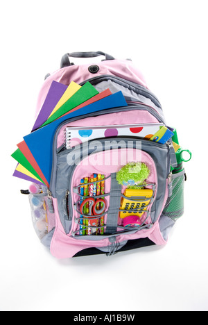 Pink book bag is filled with a student s school supplies Stock Photo