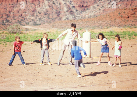 Teacher and children playing a game Lee Ranch Stock Photo