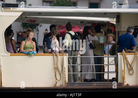 Passengers aboard vaporetto on the Grand Canal Venice Italy Stock Photo