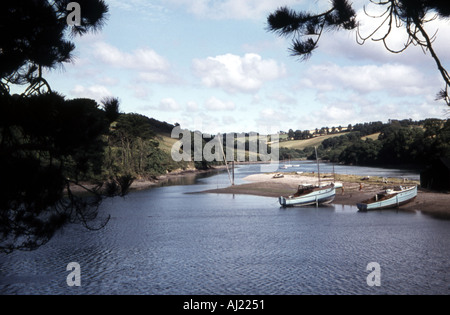 colour image off a lake which is surrounded by hillsides in the centre part is a pieceof land with some boats on it Stock Photo