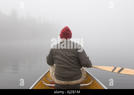 Canoe on Rain Lake in fog in Algonquin Provincial Park. Stock Photo