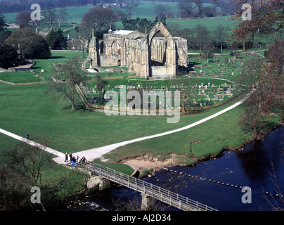 Looking down from above on ruins of Bolton Abbey also known as Bolton Priory footbridge and stepping stones crossing River Wharfe Wharfedale UK Stock Photo