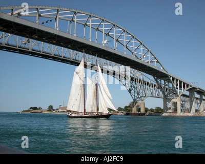 Tall Ship Highlander Sails Under Blue Water International Bridge Port Huron Michigan Stock Photo