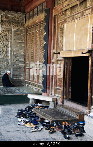 A man praying at The Great Mosque located in the Muslim Quarter, home to the city's Hui community, Xian City, Shaanxi Province Stock Photo