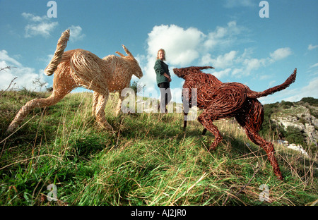 Sculptor Serena de la Hey and her wickerwork dogs at Cheddar Gorge in Somerset. Stock Photo