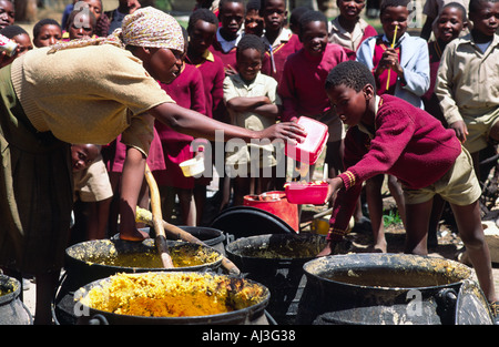 School lunch being served outside to pupils during a time of drought and food shortages. Lesotho Stock Photo