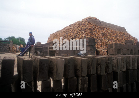 Drying bricks in a traditional brick factory in central Argentina with a man and oven on background Stock Photo