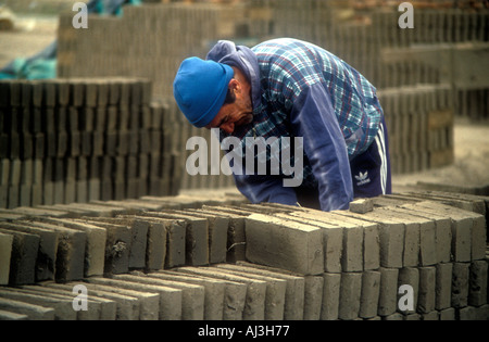 Worker man making bricks in a traditional factory in central Argentina Stock Photo