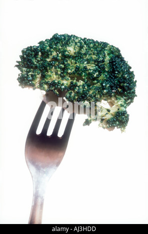Head of broccoli on fork against white background Stock Photo