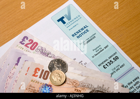 A television licence application form with cash to pay for it Stock Photo