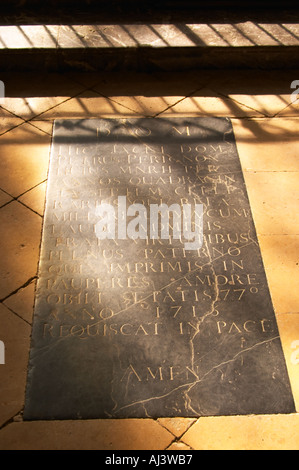 The tomb grave in a church of the monk Dom Pierre Perignon (the father of champagne) is buried, cellar master in the monastery Abbey (1639-1715). Rays of sunshine on the stone floor. Latin inscription on his tomb stone ending in Amen, the village of Hautvillers in Vallee de la Marne, Champagne, Marne, Ardennes, France Stock Photo