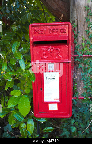 E R Post Box Symbol Red British post box with 'ER' symbol in front of a stone building with ...