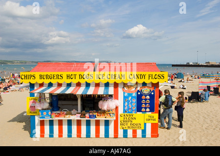 A quick food stall selling unhealthy food on a crowded beach at Weymouth on a bright summers day. Stock Photo