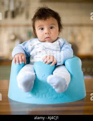 Baby boy sitting in his chair Stock Photo