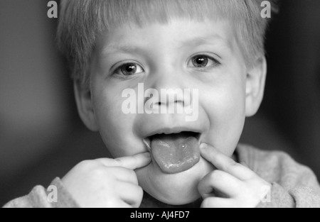 Young boy sticking out tongue Stock Photo