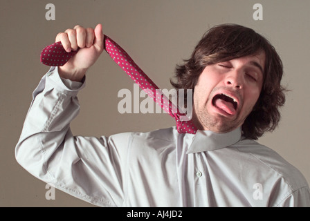 Young Man Unhappy with Office Job Stock Photo