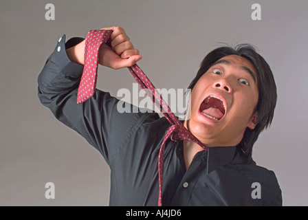 Tie choking stressed businessman Stock Photo