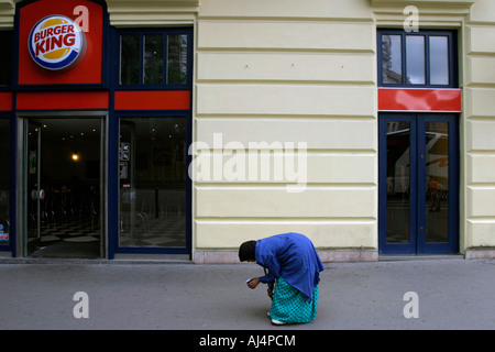 Bent old woman walking on the street begging Budapest Hungary Stock Photo