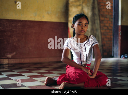 Young student sitting on the floor before a class in traditional dance at the Fine Arts School in Phnom Penh Cambodia Stock Photo