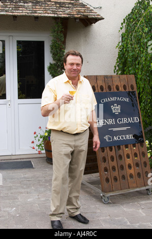 Claude Giraud, owner and winemaker, tasting a glass of his wine in the court yard in front of his house Champagne house Maison Giraud-Hemart, also called Champagne Henri Giraud, Ay, Vallée de la Marne, Champagne, Marne, Ardennes, France Stock Photo