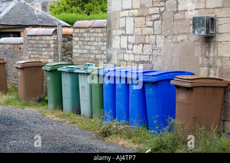 Green blue and brown plastic wheelie bins used for recycling household waste in the South Ayrshire town of Troon Scotland Stock Photo