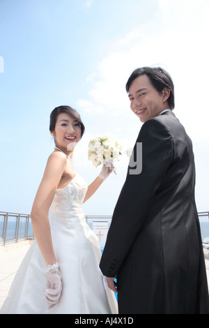 Bride and groom looking at camera Stock Photo