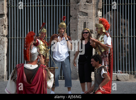Imitation gladiators stand outside the Colosseum and get photographs taken with tourists Rome Lazio Italy Stock Photo