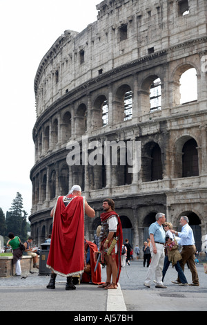 Imitation gladiators stand outside the Colosseum to get photographs taken with tourists Rome Lazio Italy Stock Photo