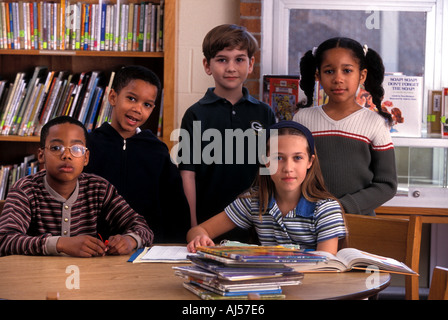 Portrait of multiracial group of students in elementary school library Stock Photo