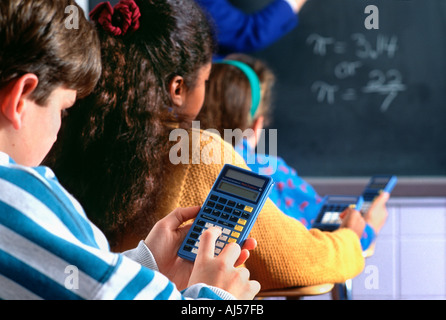 Students using calculator in Middle School math class Stock Photo
