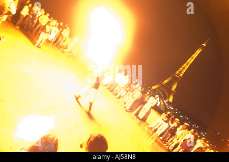 People spitting fire and celebrating during the Fete de la Musique, with the Eiffel tower in background, Paris, France Stock Photo