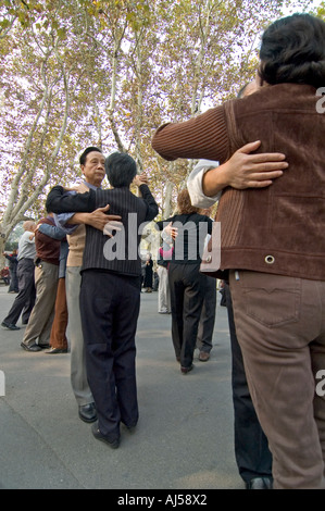 Chinese couples dancing in Fuxing Park, in the French Concession Area of Shanghai, China Stock Photo