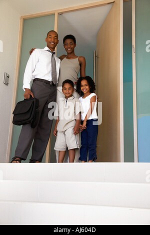 Family standing in doorway Stock Photo