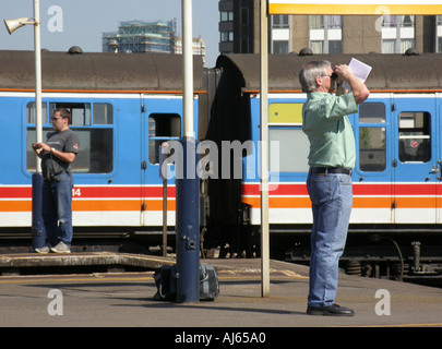 trainspotters on the platform at Clapham Junction a prime trainspotting station Stock Photo