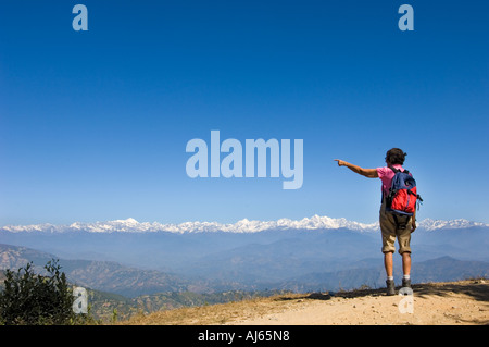 trekki woman shows NAGARKOT HIMALAYA Resort mountain range of hills Kathmandu valley NEPAL Asia Katmandu anapurna range Stock Photo