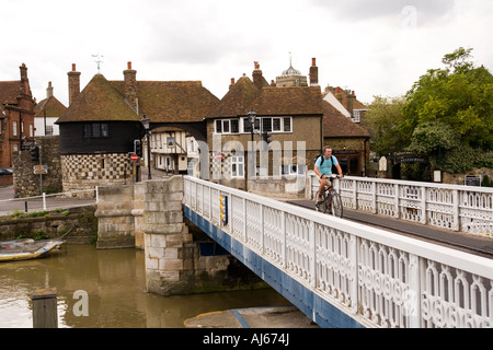 UK Kent Sandwich Quay cyclist crossing former toll bridge over River Stour at The Barbican Tudor town gate Stock Photo