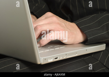 young bussiness woman working with laptop on her legs, Germany Stock Photo