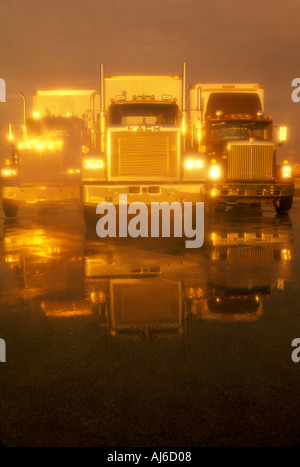 Three Big Rigs Three tractor trailer truck rigs head on Stock Photo - Alamy