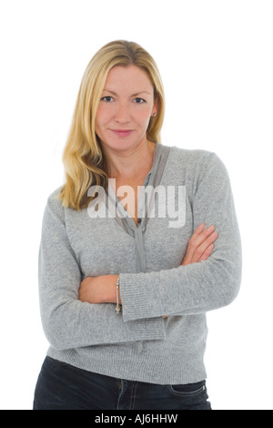 Isolated studio shot of an attractive thirty something young woman arms crossed and looking thoughtful Stock Photo