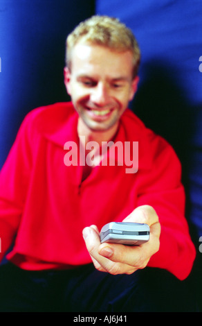 Young man writing an SMS. Stock Photo