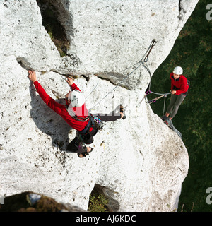 Two people climbing mountain. Stock Photo