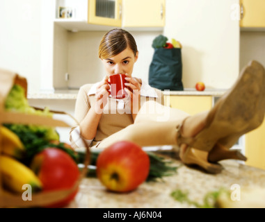 Young woman resting in the kitchen. Stock Photo