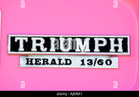 Pink Triumph Herald 13/60 car badge UK Stock Photo