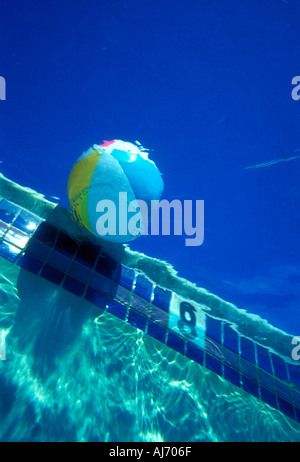 Underwater view of inflatable beach ball in floating in swimming pool Property released image Stock Photo